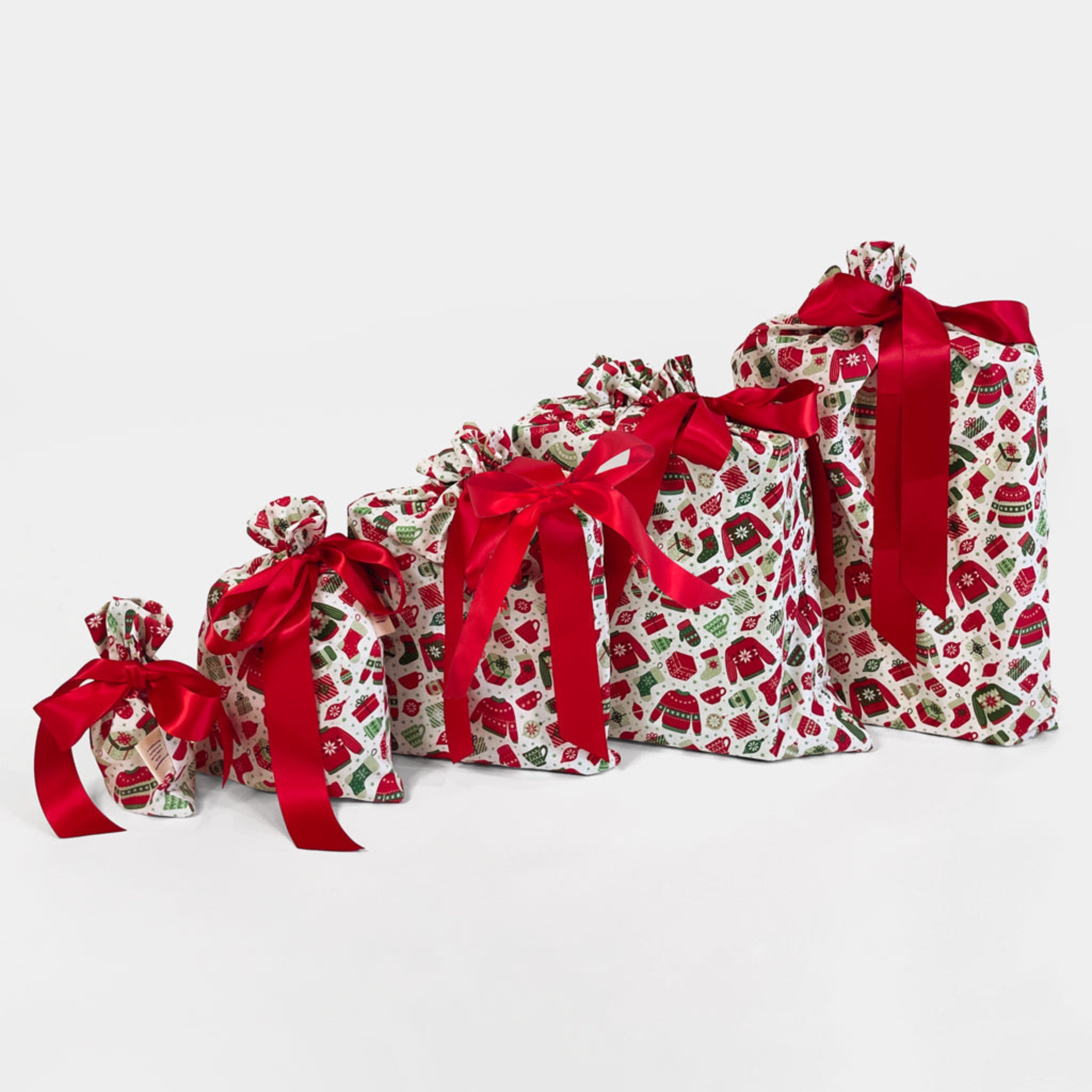 Set of decorative bags with red ribbons on a white background