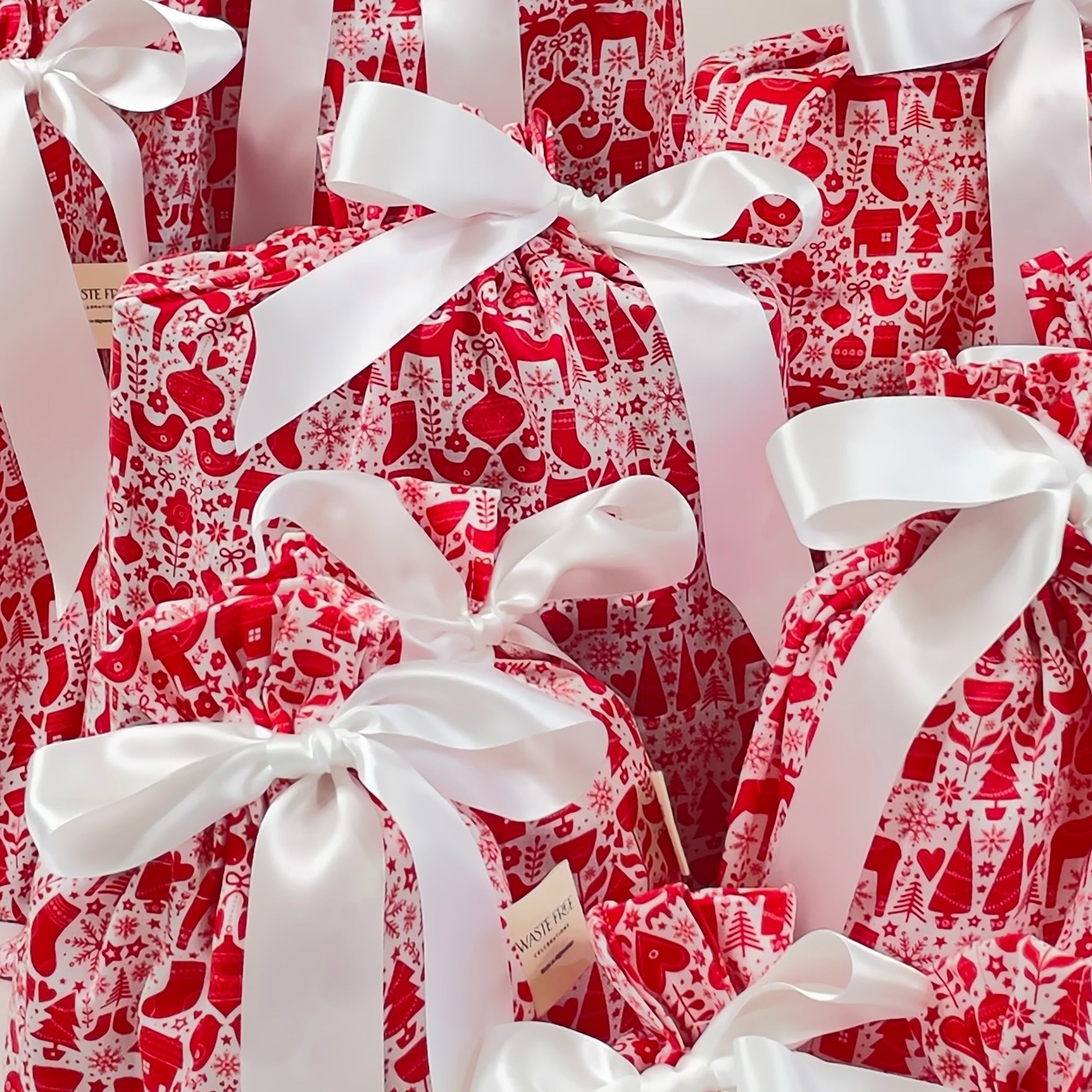 Red and white patterned gift boxes with white ribbons