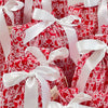 Red and white patterned gift boxes with white ribbons