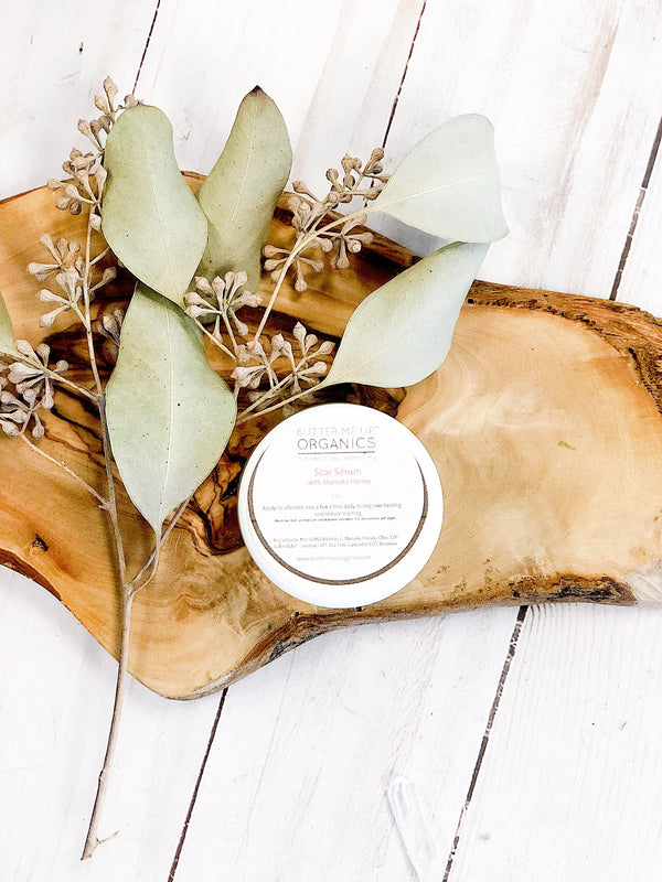 Close-up of Butter Me Up Organics Scar Serum label showing Manuka Honey and Vitamin E formula