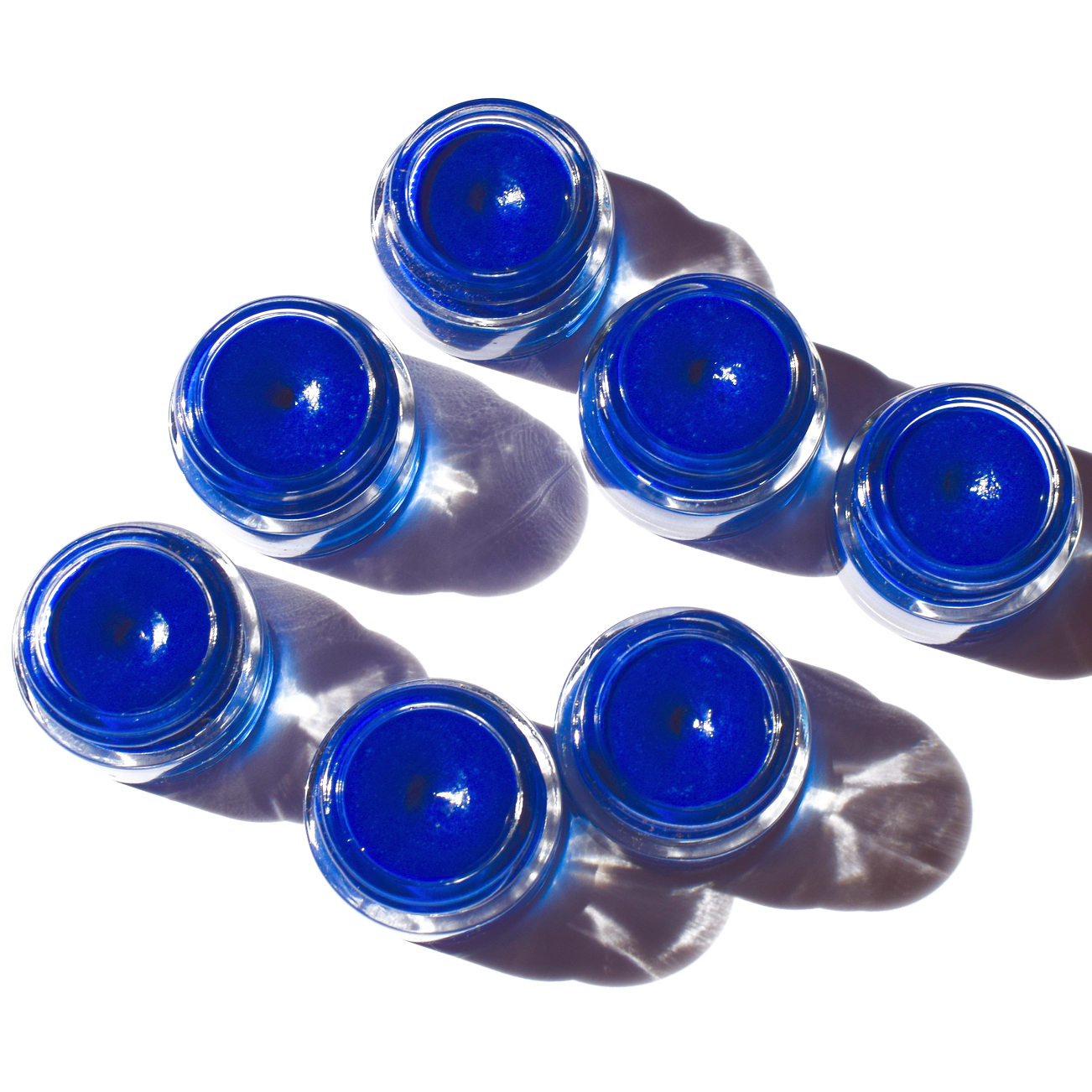 Close-up of SEA Creature blue spirulina tinted lip balm jar by Plant Makeup, showing minimal eco-friendly packaging