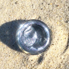 Metallic object on sandy ground