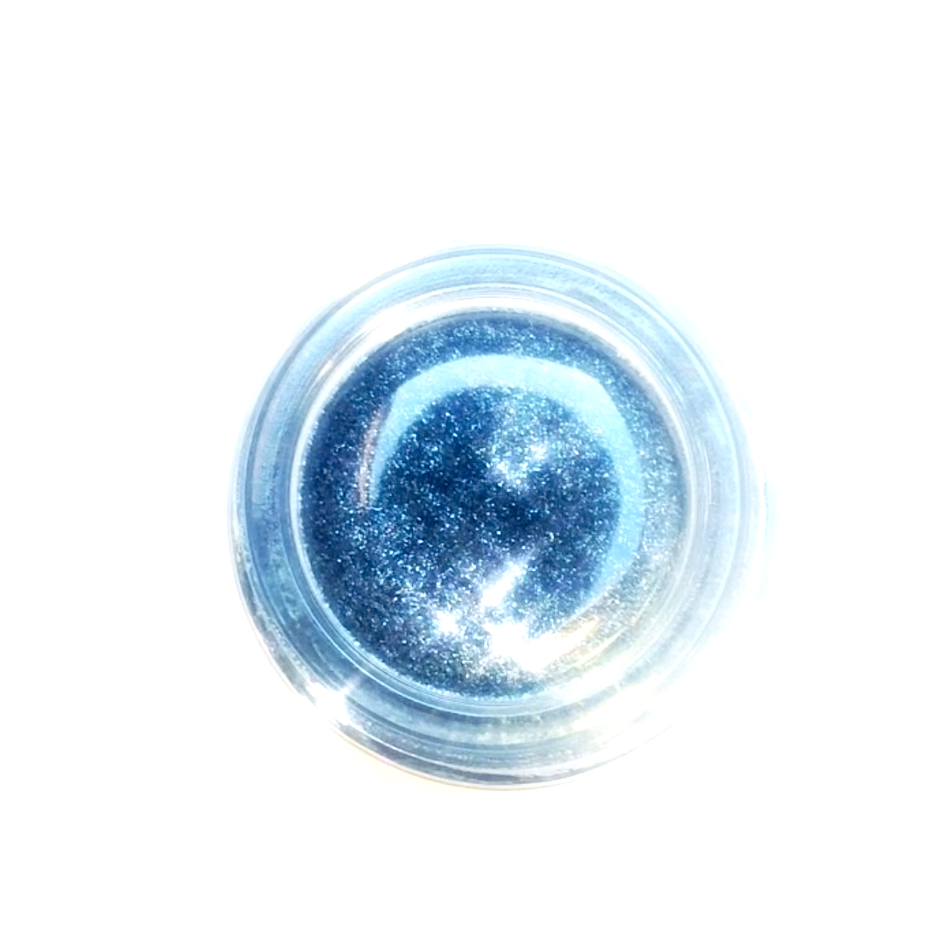 Small container of blue glitter on a white background