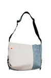 Recycled denim patchwork crossbody bag with bottle cap strap detail and adjustable woven strap