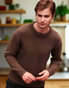 Man wearing a brown sweater in a kitchen setting