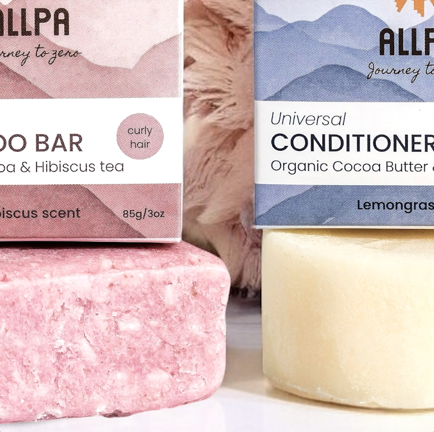 Pink soap bar and blue conditioner bottle with Allpa branding on a white background