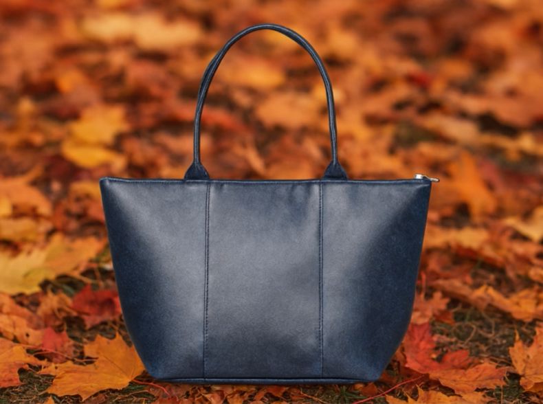 Blue handbag on a background of autumn leaves