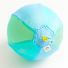 Child playing with the Sarah's Silks Sea Balloon Ball outdoors in a garden setting