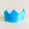Blue paper crown on a light beige background