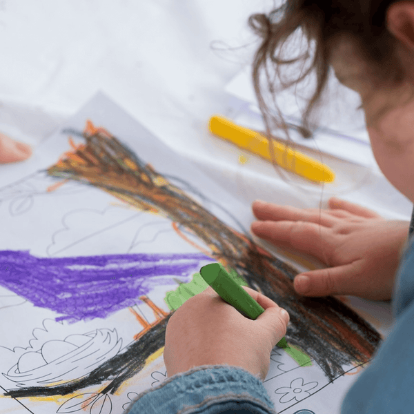 Elseware Unplug beeswax crayons displayed at outdoor event with natural surroundings