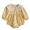 Baby wearing the Paisley Lapel Romper with lapel collar detail