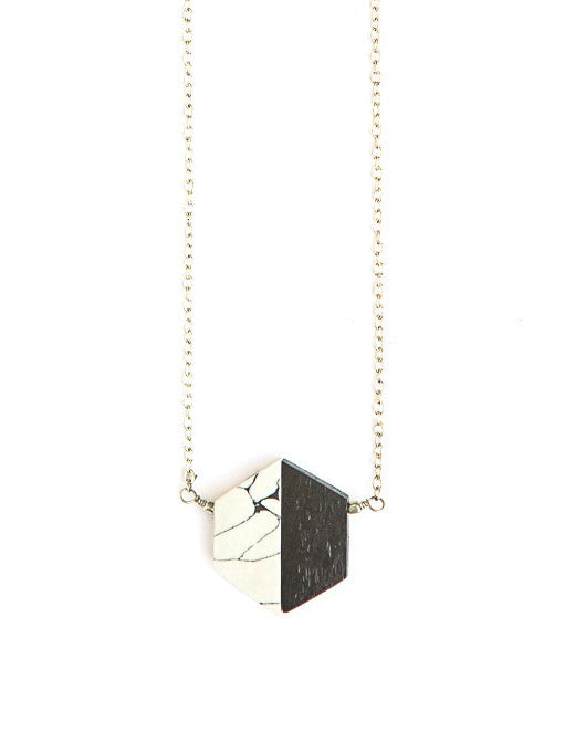 Short black hexagon necklace in black resin and silver-plated metal by Fair Anita, worn as a standalone piece