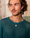 Silver globe pendant necklace on a fine silver chain, shown as a layered jewellery look