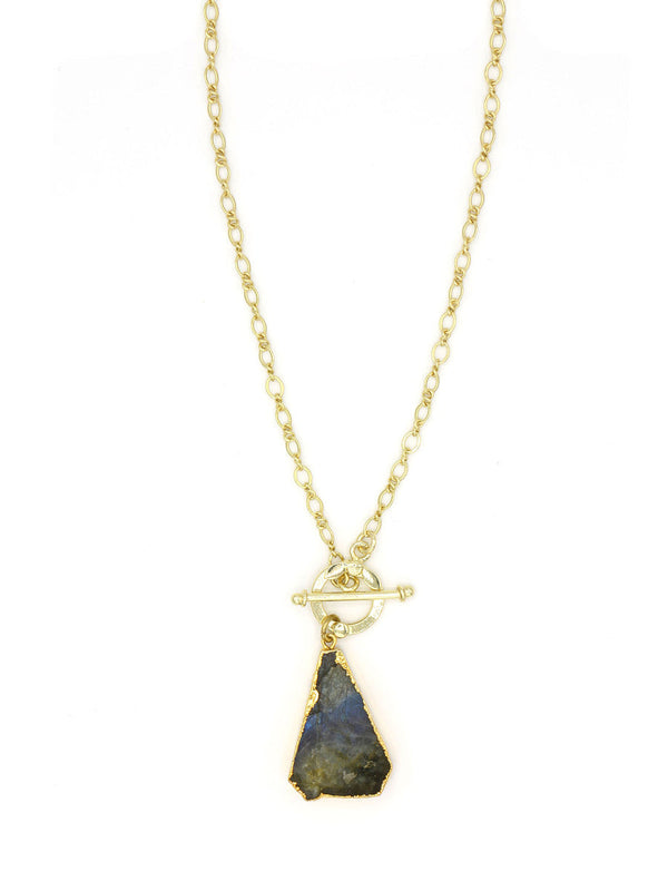 Flat lay of the Simple Luxury Labradorite Necklace by Fair Anita on a neutral background