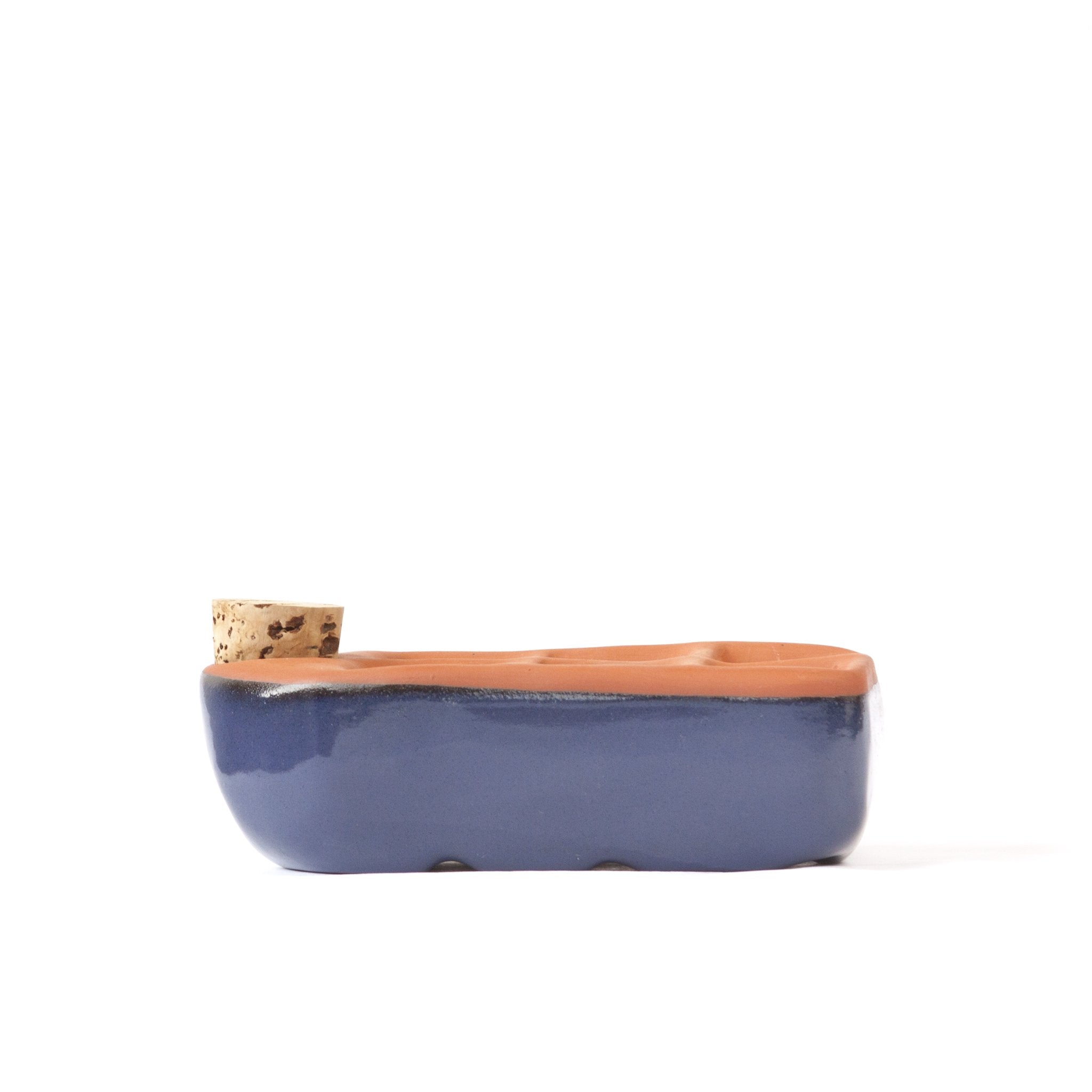 Sixie self-watering seed starter pot in cobalt blue with organic seedlings growing, part of the Orta Gardens seed kit