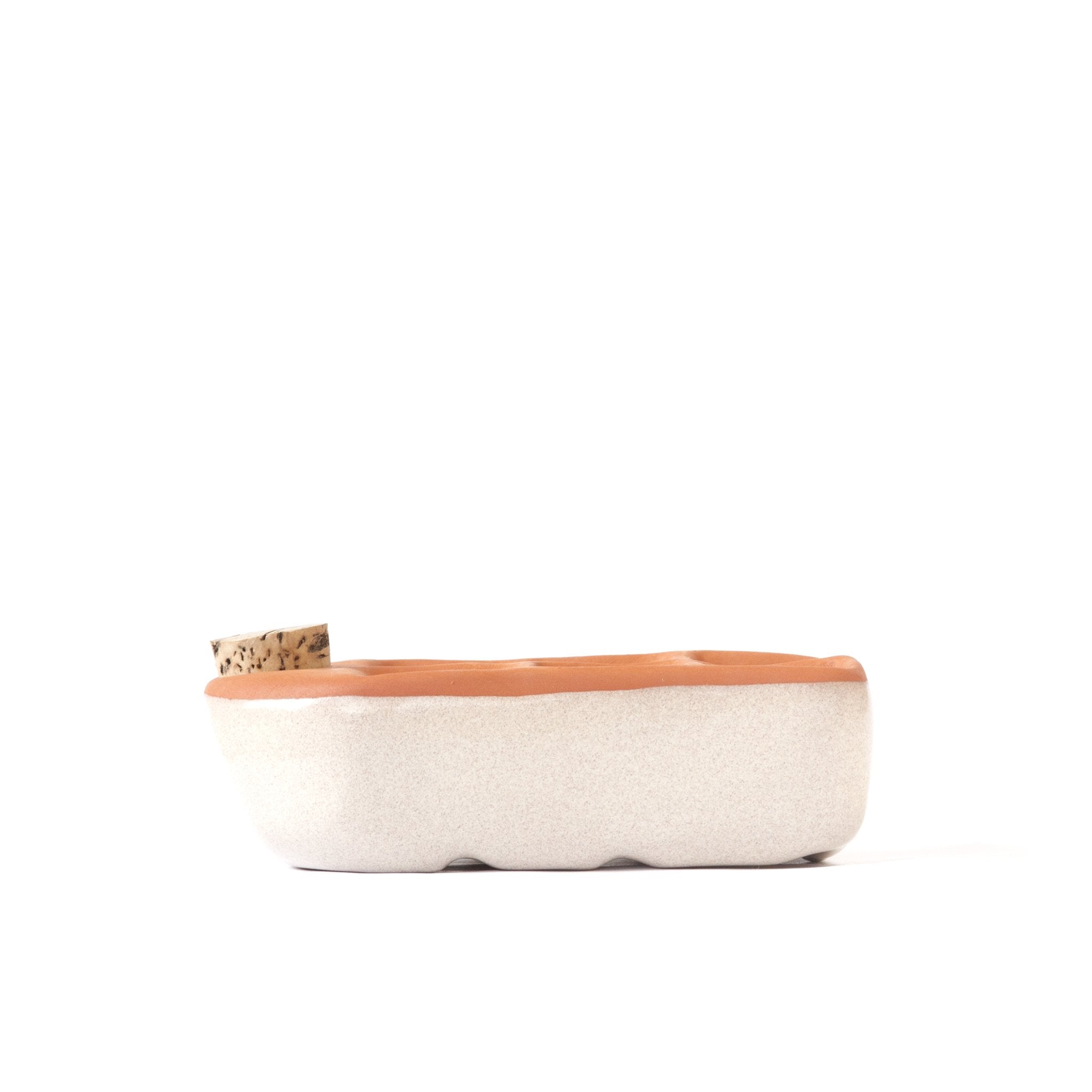 Rectangular basket with a cork lid on a white background
