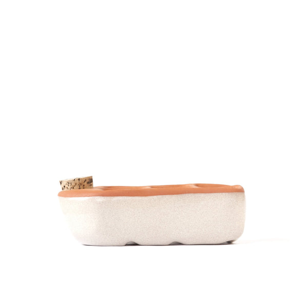 Rectangular basket with a cork lid on a white background