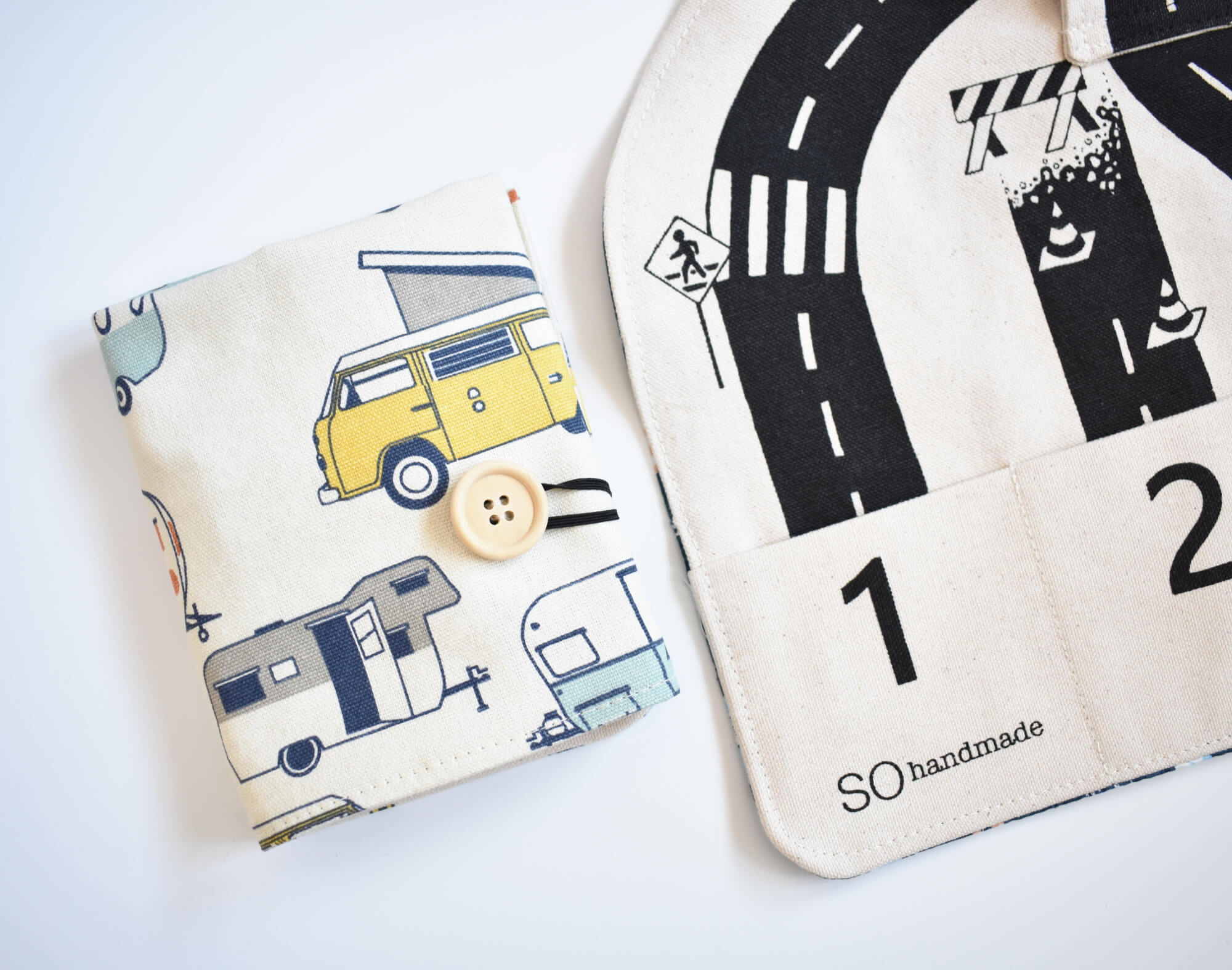 Two fabric items with road and vehicle patterns on a white background