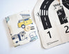 Two fabric items with road and vehicle patterns on a white background
