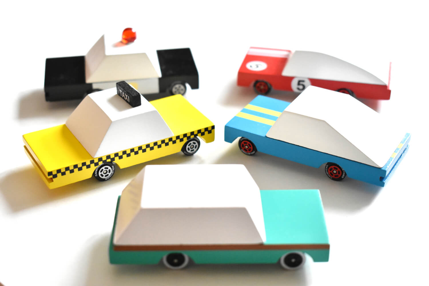 Colorful toy cars made from paper or cardboard on a white background