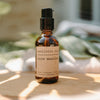 A bottle labeled 'sore muscles' with a blend of arnica oil, juniper, wintergreen, peppermint, and lavender for massage use.