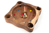 Wooden game board with holes and colored balls on a white background