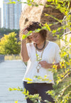 Fair Anita Beaming Rays Artillery Necklace worn layered with other necklaces in a bohemian style