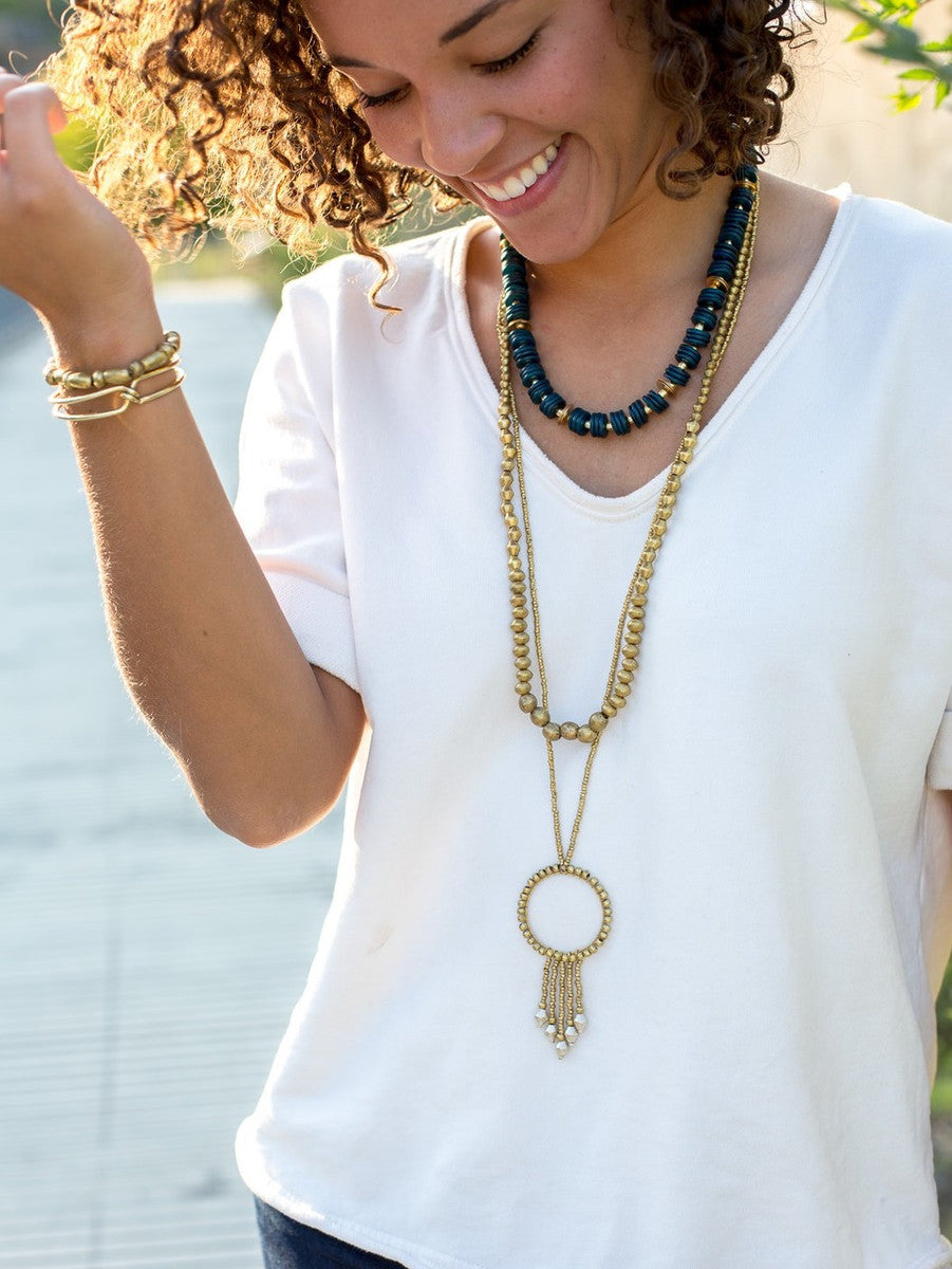 Beaming Rays Artillery Necklace styled in a layered stack with bone and graduated bead necklaces