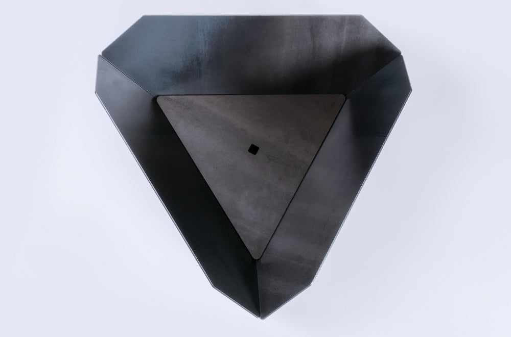 Black geometric wall art piece on a white background