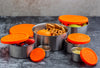 Set of stainless steel containers with orange lids on a gray surface