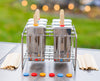 Popsicle mold with colorful sticks on a metal rack outdoors