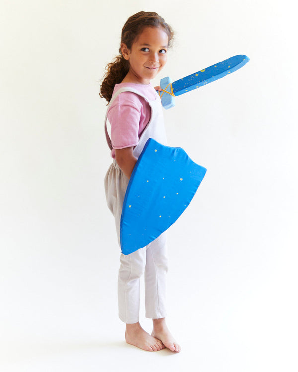 Child in a blue dress-up sword and cape on a white background