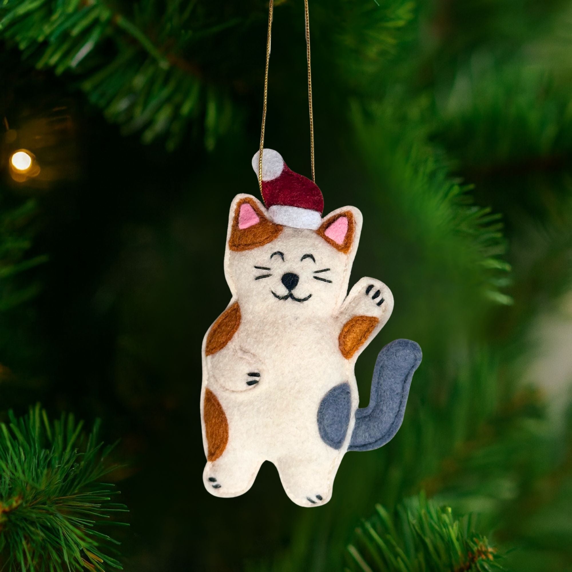 Close-up of the Stealing Santa Hat Cat Ornament showing hand-stitched details