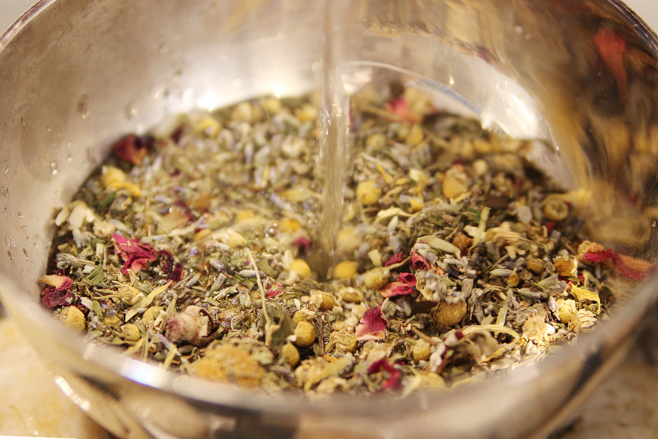 Close-up of herbal steam facial blend botanicals including lavender, calendula and mint in recyclable jar