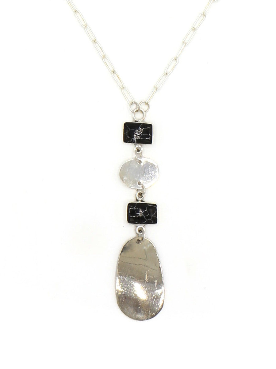 Close-up of the Stepping Stone Pendant Necklace showing silver and black pendant detail, by Fair Anita