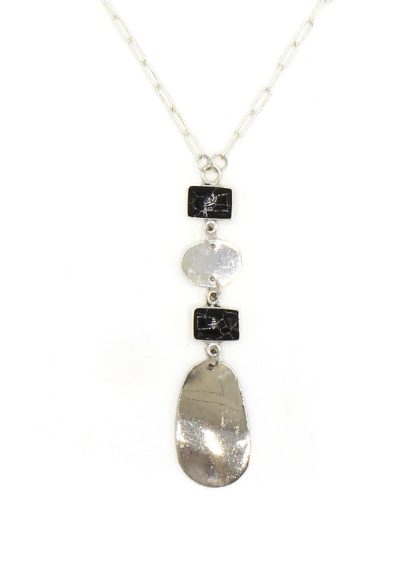 Close-up of the Stepping Stone Pendant Necklace showing silver and black pendant detail, by Fair Anita