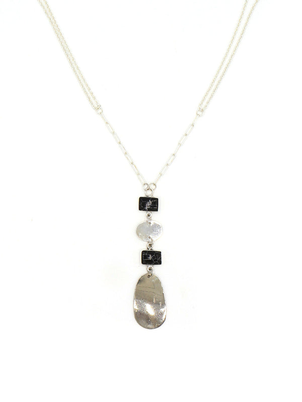 Close-up detail of the Stepping Stone Pendant Necklace silver chains and black pendant by Fair Anita