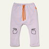 Light purple baby pants with orange drawstring and black lemon illustrations on a white background