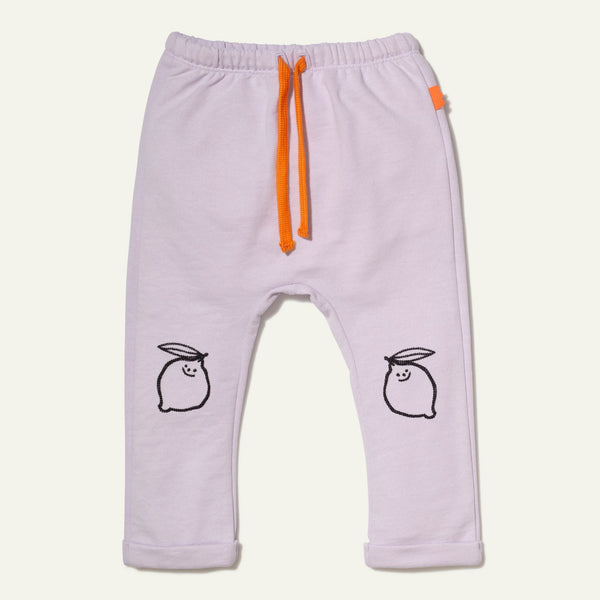Light purple baby pants with orange drawstring and black lemon illustrations on a white background