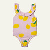 Pink one-piece swimsuit with lemon pattern on a light gray background