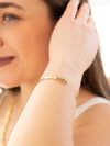 Close-up of subtle brass feminist cuff bracelet by Fair Anita