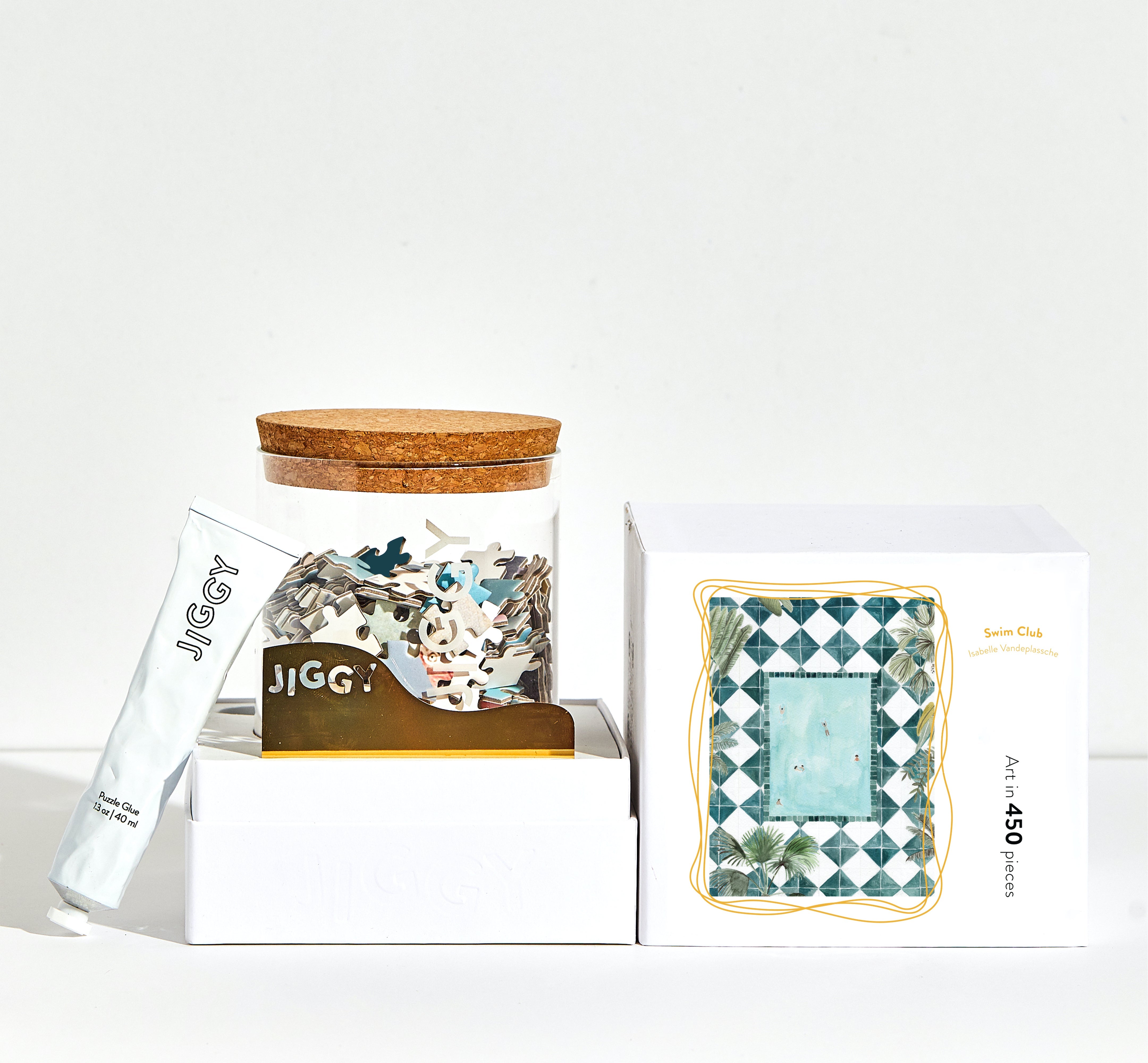 JIGGY puzzle packaging with wooden lid and decorative box on a white background