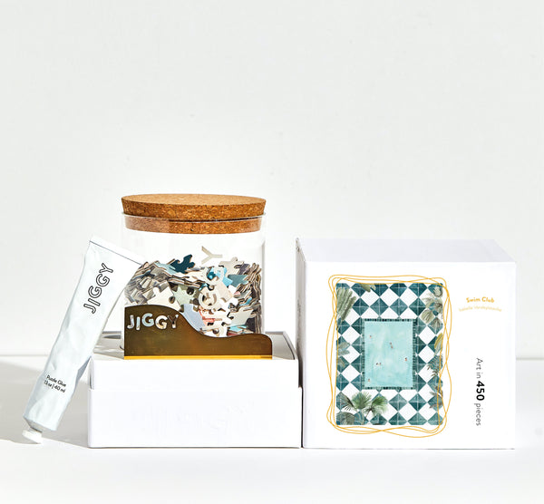 JIGGY puzzle packaging with wooden lid and decorative box on a white background