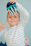 Child in Apple Park Breezy Bay Stripe pajamas showing soft elastic waistband and ribbed ankle cuffs detail