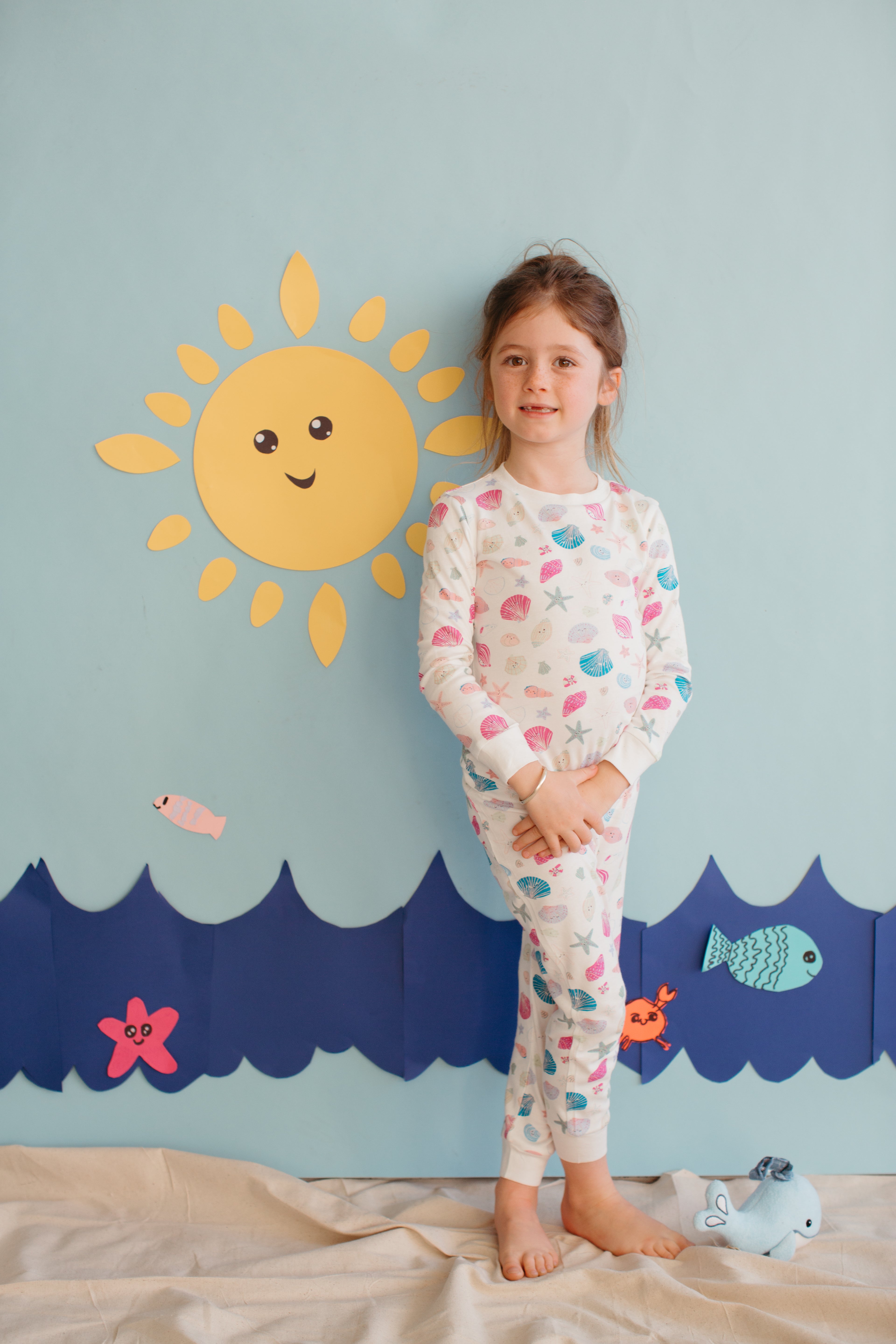 Child wearing Apple Park Seaside Treasures two-piece bamboo pajamas with ocean-inspired print