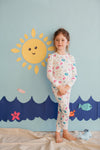 Child wearing Apple Park Seaside Treasures two-piece bamboo pajamas with ocean-inspired print