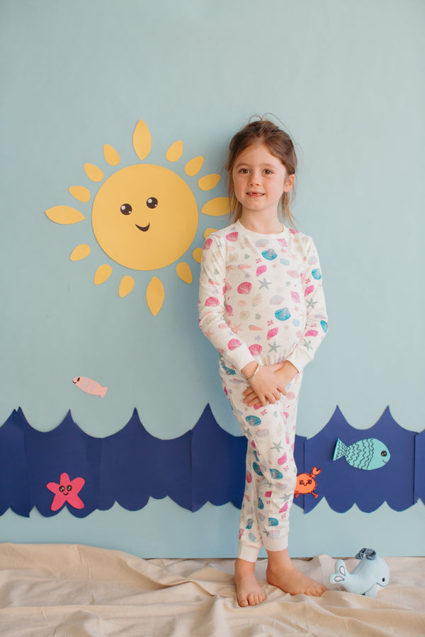Child wearing Apple Park Seaside Treasures two-piece bamboo pajamas with ocean-inspired print