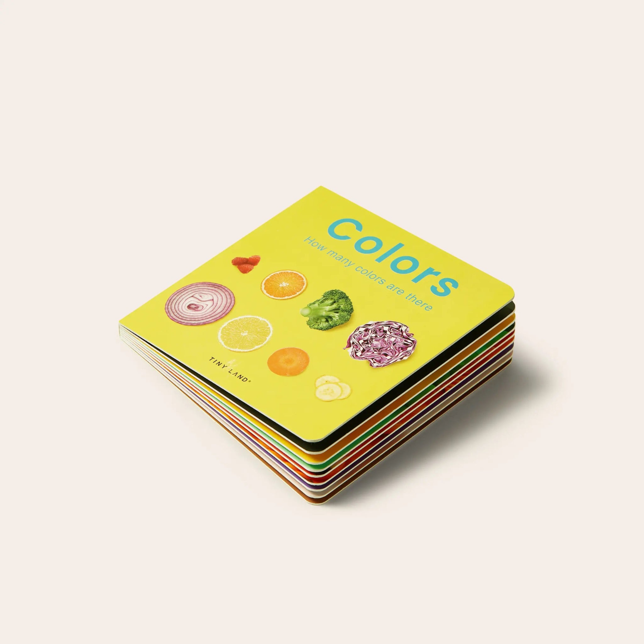 Stack of colorful children's books titled 'Colors' on a light background