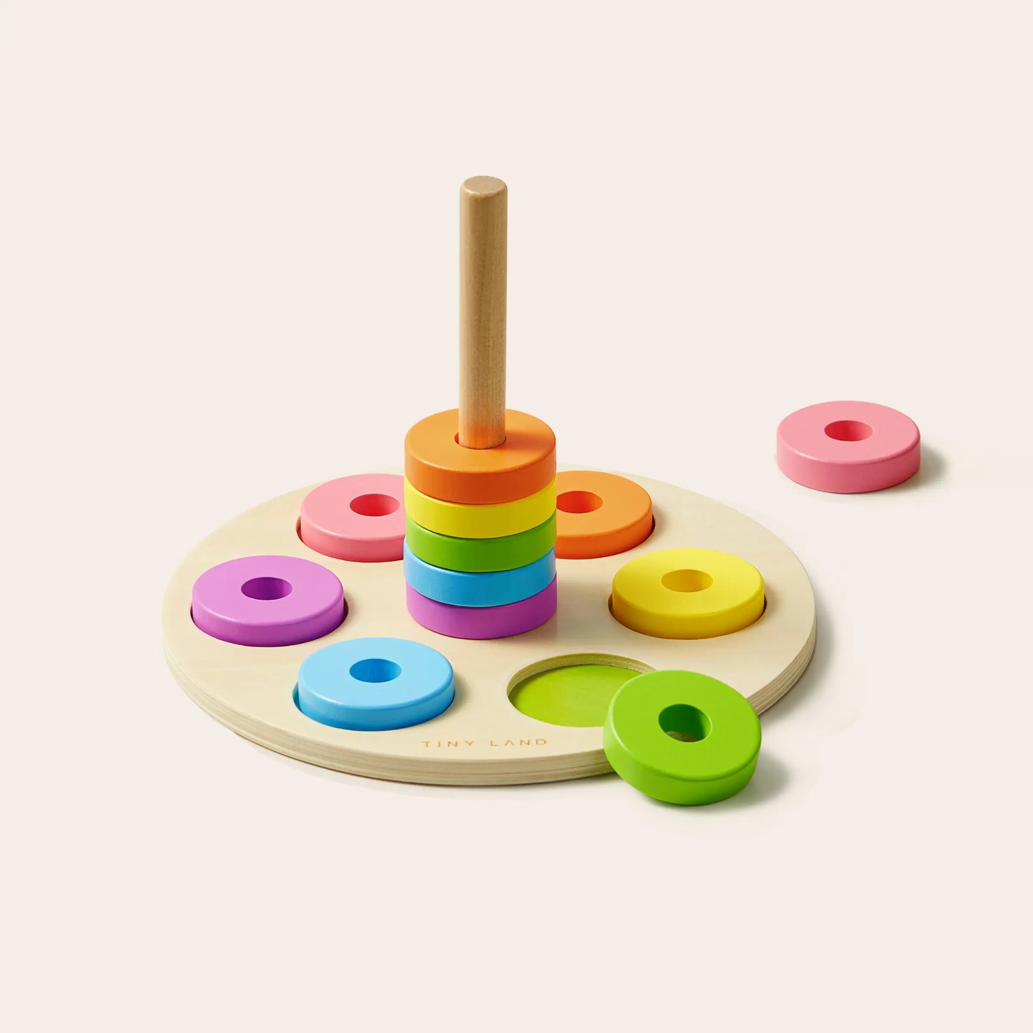 Colorful wooden stacking toy with rings on a white background