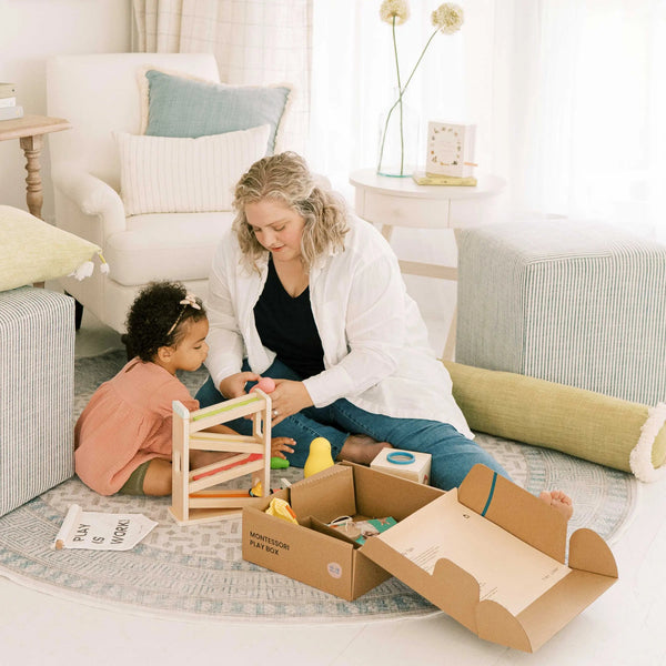 Woman and child playing with toys on a rug in a living room